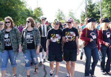 Twins walking together  Twins Day Festival in Twinsburg Ohio to illustrate Will ‘dual enrolment’ surge promote social equity