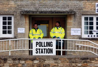 Security staff stand at the polling station to illustrate I’m a bouncer, but don’t ask me to evict students from polling booths
