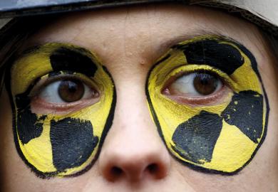 Close up of face with eyes painted circles yellow and black 