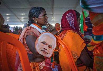 Supporters of the Bharatiya Janata Party (BJP) gather to hear India's Prime Minister Narendra Modi speak to illustrate Is Modi’s electoral setback  a win for Indian HE?