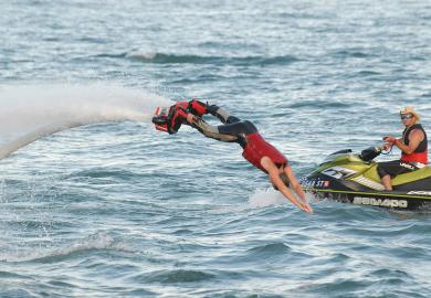 Person dives into the water on a flyboard at the Detroit river front
