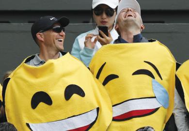Two men wearing emoji costumes laughing asametaphor for Is optimism justified?