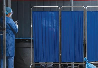 A man is tested behind a screen at the General Hospital 