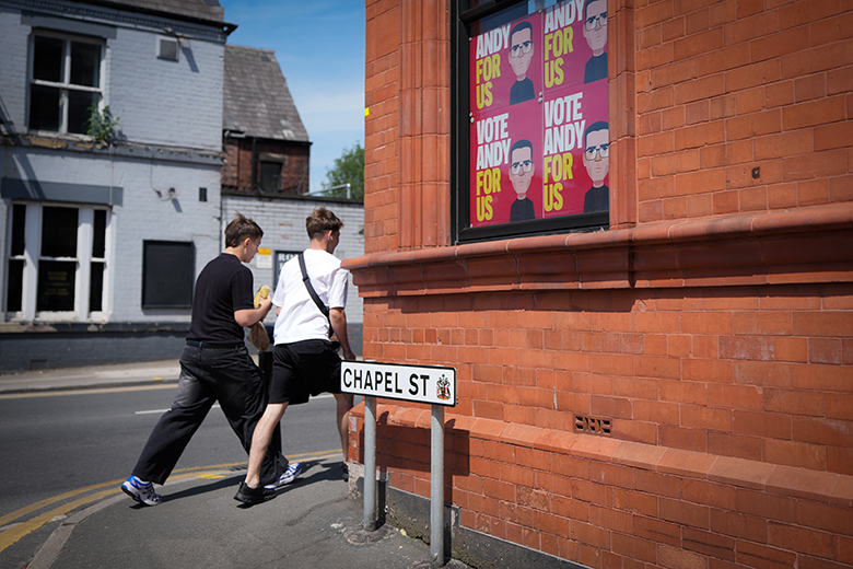 Young boys walking past “Vote Andy For Us” Labour by-election campaign placards depicting Andy Burnham that adorn the Cross Keys pub on 27 May 2026 in Ashton-in-Makerfield, England. Young boys walking past “Vote Andy For Us” Labour by-election campaign placards depicting Andy Burnham that adorn the Cross Keys pub on 27 May 2026 in Ashton-in-Makerfield, England.