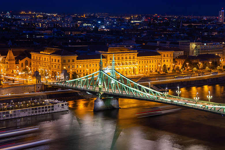 Evening panorama of Budapest with the Danube and the Liberty Bridge in the foreground and Corvinus University. Evening panorama of Budapest with the Danube and the Liberty Bridge in the foreground and Corvinus University.