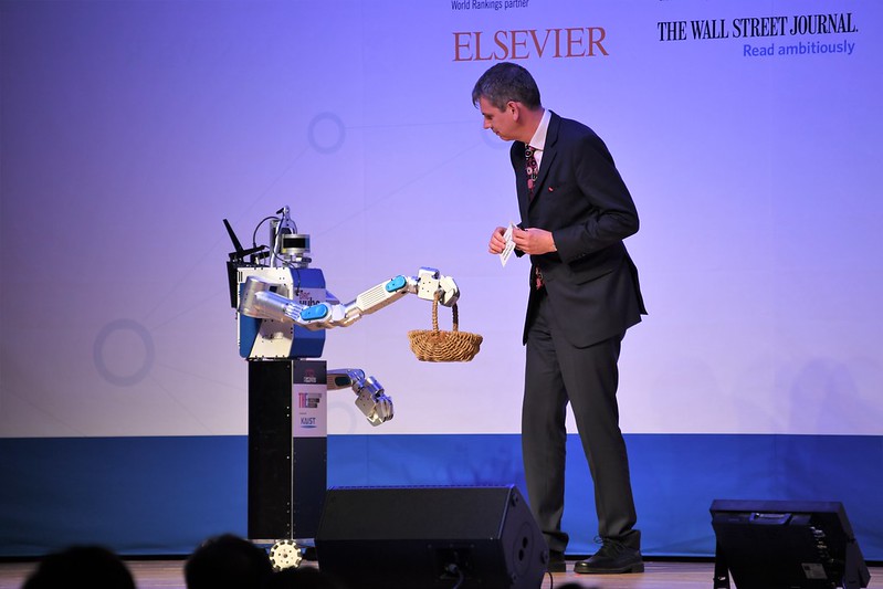 Data editor Duncan Ross and a robot at an Innovation & Impact Summit