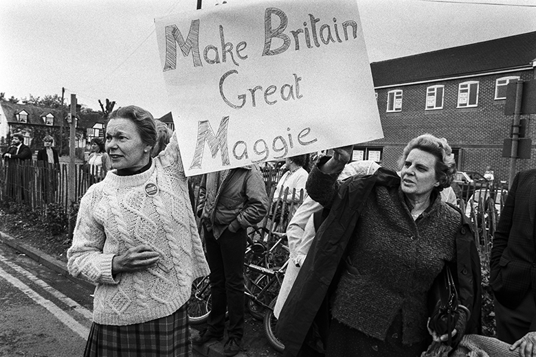 Supporters of Margaret Thatcher hold a sign stating “Make Britain Great Maggie” in Newbury, 27 May 1983.