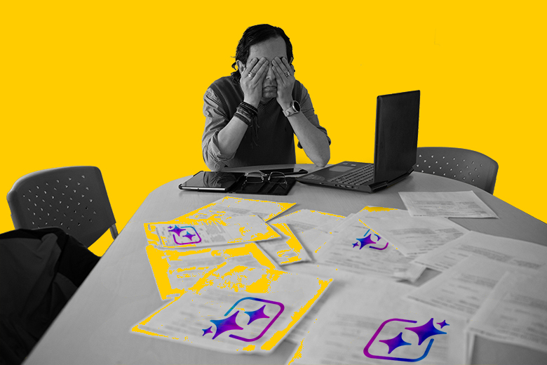 A man with his head in his hands with exam papers on his desk, some of which have an AI sparkle icon on them. To illustrate how difficult it is to tell apart papers that have been written using AI and those that have not.