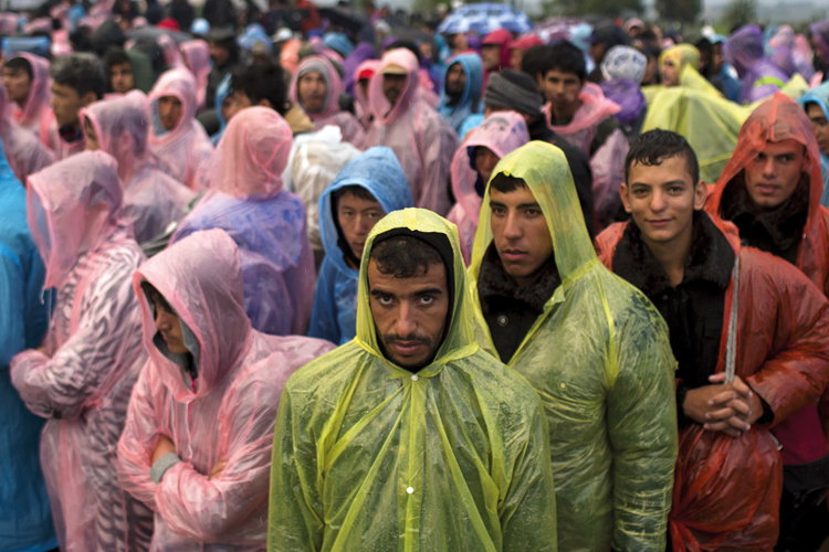 Migrants standing in field near Tovarnik, Croatia, 2015