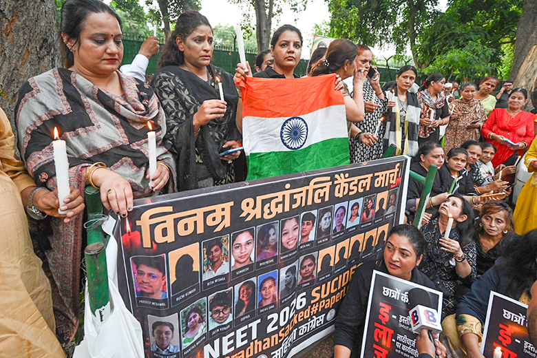 Women participate in a candlelit march in support of students who took their own lives after learning they would have to resit the NEET Women participate in a candlelit march in support of students who took their own lives after learning they would have to resit the NEET