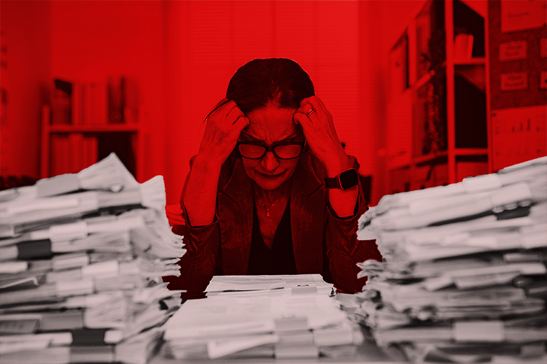 An editor with a large number of paper files on her desk. To illustrate the huge number of manuscripts that are handled by editors. An editor with a large number of paper files on her desk. To illustrate the huge number of manuscripts that are handled by editors.