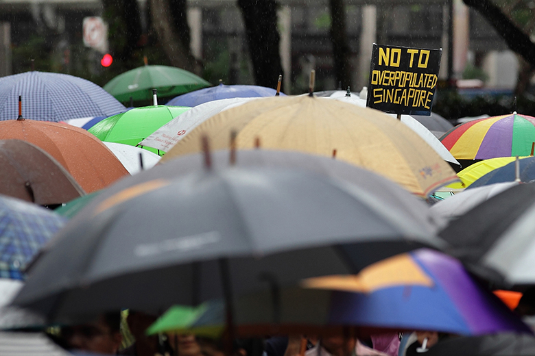 Singapore residents protesting against an increase in population when they already see a strain on housing, transportation and healthcare. Singapore residents protesting against an increase in population when they already see a strain on housing, transportation and healthcare.