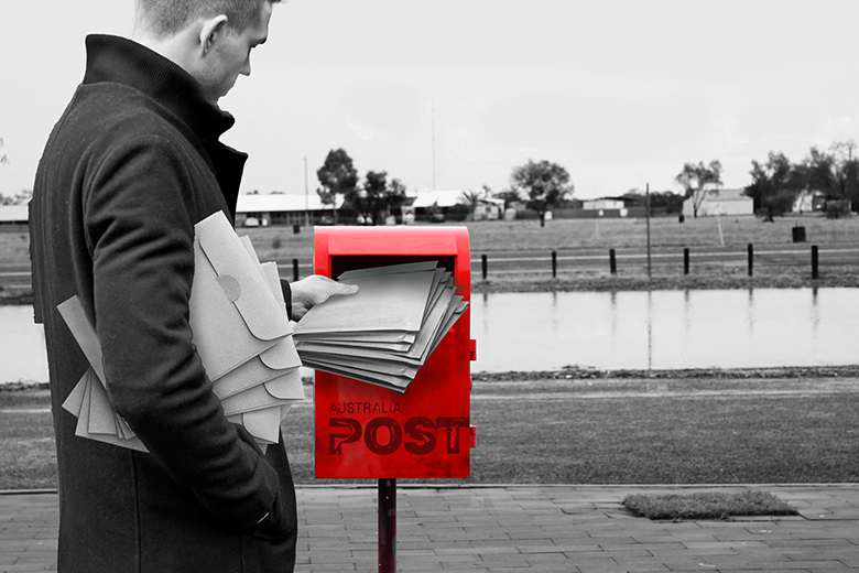 A man stuffing piles of letters into a postbox. To illustrate a prolific author submitting papers. A man stuffing piles of letters into a postbox. To illustrate a prolific author submitting papers.