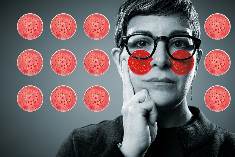 Red faced scientist with petri dish