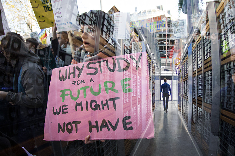 A student climate protester overlaid on to the interior of a data centre. To illustrate a conflict of mass AI roll-outs with net-zero targets. A student climate protester overlaid on to the interior of a data centre. To illustrate a conflict of mass AI roll-outs with net-zero targets.
