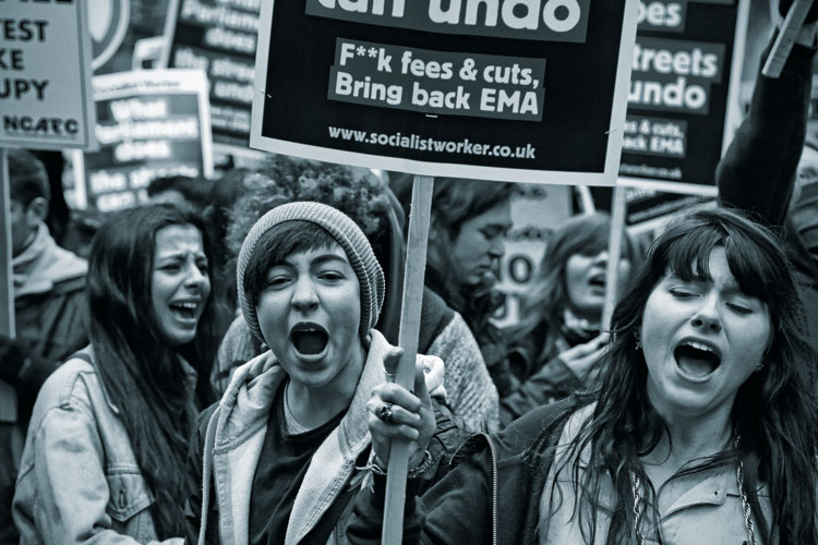 A student holding a placard at a protest