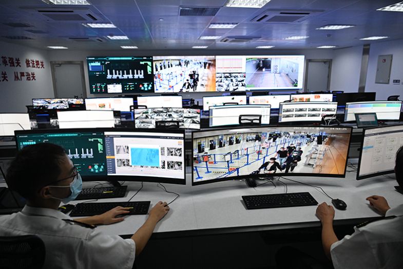 Staff members monitor screens in a control room at Shanghai Pudong International Airport in Shanghai, China. To illustrate that Western researchers fear they are being monitored when travelling to China.