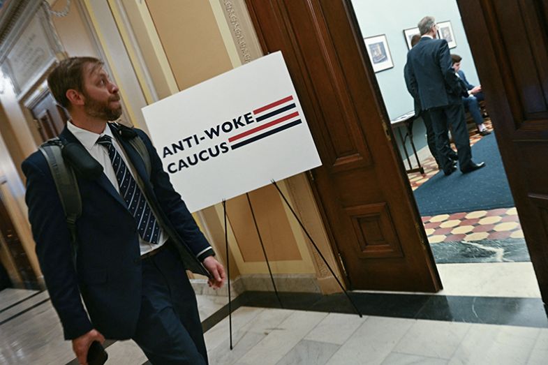 A man passes by a room holding a meeting by the Anti-Woke Caucus on the House of Representatives side of Capitol Hill in Washington, DC, on 6 May 2025.