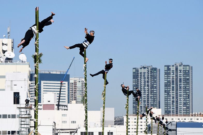 Edo Firemanship Preservation Association members balance on top of bamboo ladders during a presentation in Tokyo, 2018.
