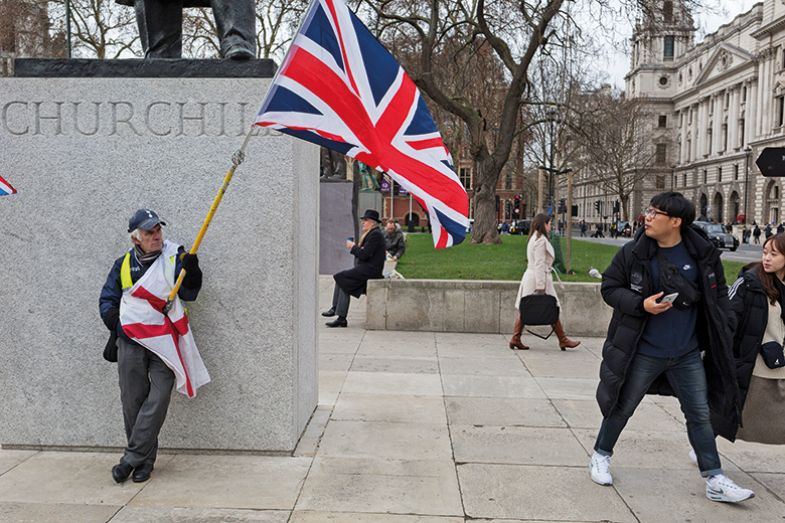 Brexit. A Leave supporter comes face to face with a tourist beneath the statue of Winston Churchill in Parliament Square. To illustrate how the UK is not always welcoming to overseas students