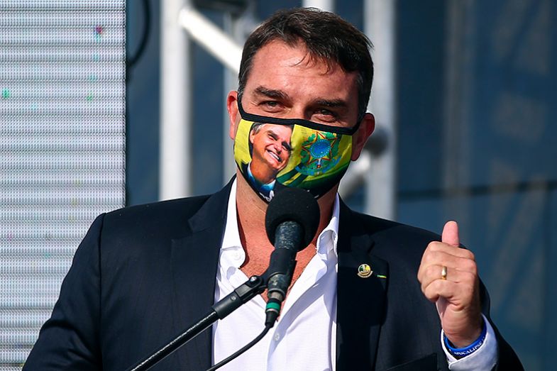 Flávio Bolsonaro speaks during the opening ceremony of the festivities for the 90th anniversary of the statue of Christ the Redeemer on 1 March 2021 in Rio de Janeiro, Brazil. He is wearing a facemask depicting his father Jair Bolsonaro.