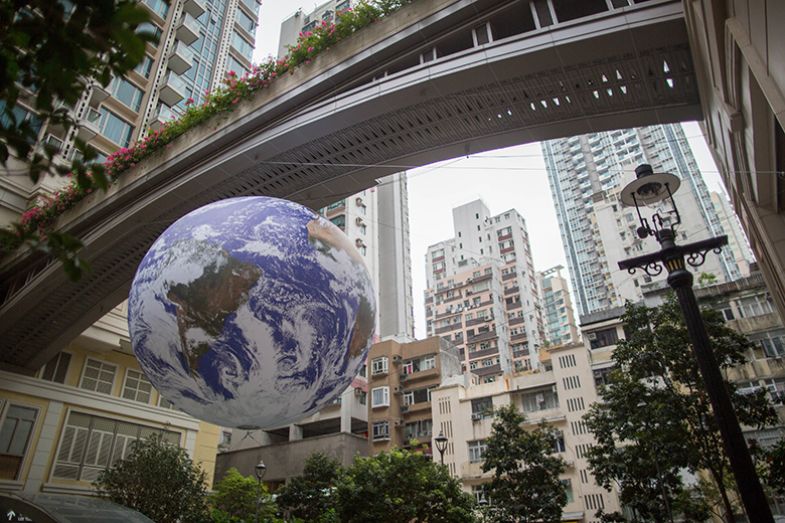 Earth Globe ‘Gaia’ by artist Luke Jerram set up to raise awareness about global warming seen in the Wan Chai district of Hong Kong Island. To illustrate whether Hong Kong can succeed at being an international academic hub.