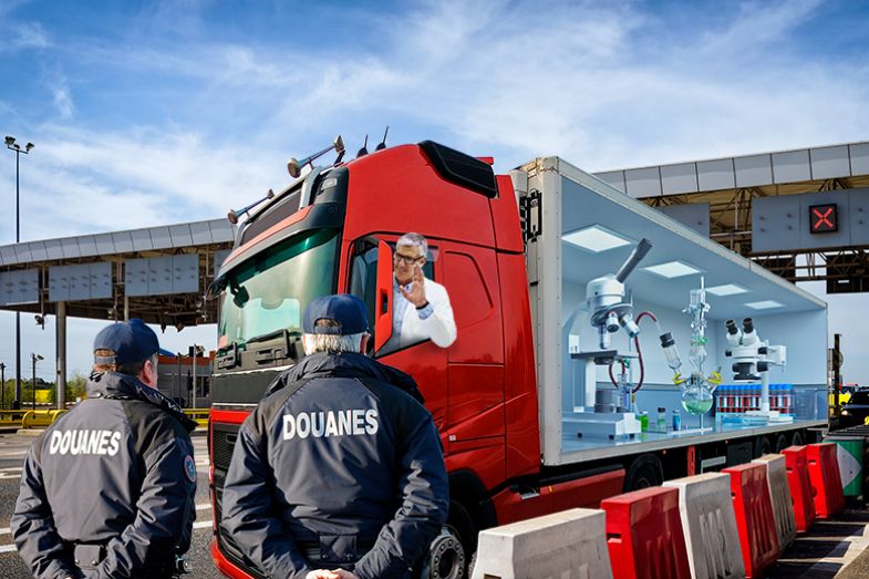 Scientist driving a truck filled with his laboratory across a border. To illustrate free movement for research in the European Research Area.