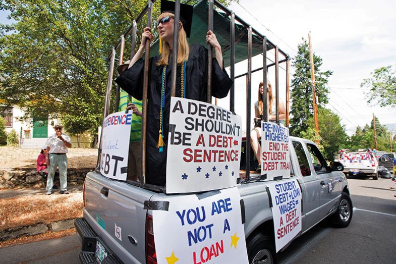 Students with placards on the back of a pick-up truck