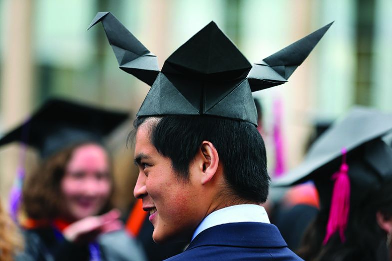 Student wears a home-made origami graduation cap at the Olin College of Engineering “Fauxmencement” for senior students in March 2020