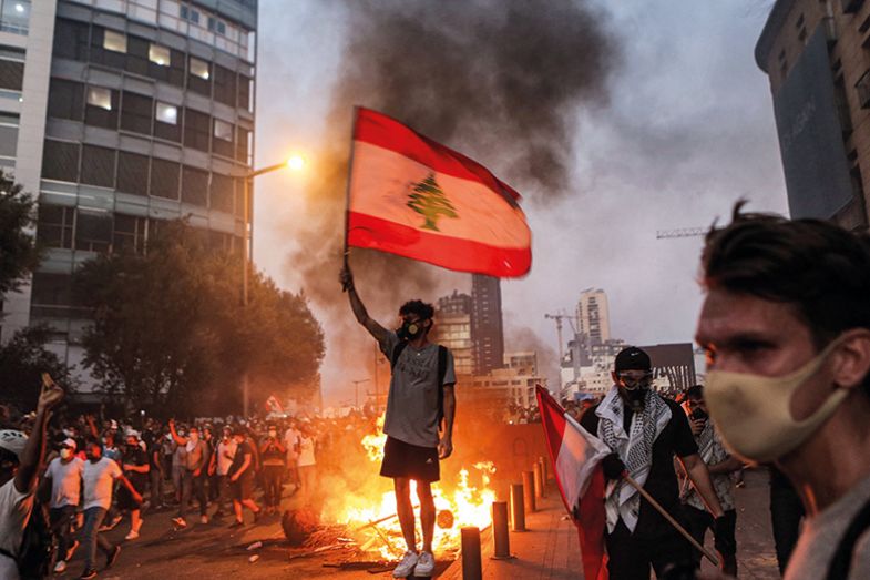 Protester stands with a Lebanese national flag