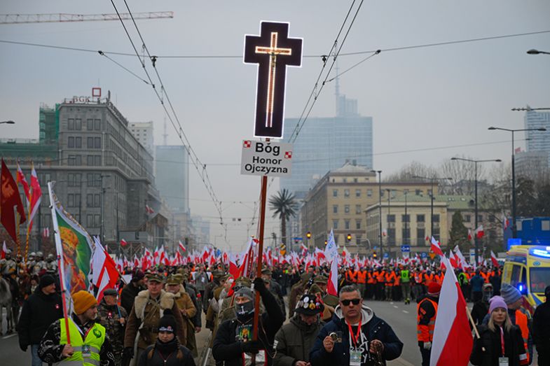 A man holds a cross during the Independence Day march in Warsaw, Poland on 11 November 2024. A march organised by far-right, nationalist organisations was allowed to proceed.