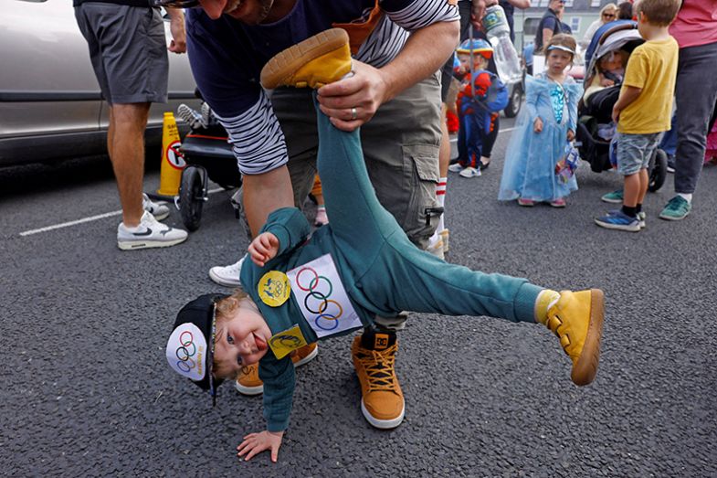 Child dressed as the Australian Olympic breakdancer Rachael Gunn (Raygun), who participated in the sport of breaking, is held by his dad at a children’s fancy dress parade, Ireland, 18 August 2024. Child dressed as the Australian Olympic breakdancer Rachael Gunn (Raygun), who participated in the sport of breaking, is held by his dad at a children’s fancy dress parade, Ireland, 18 August 2024.