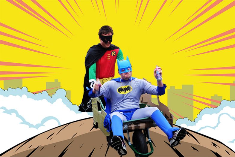 Superhero Robin carrying Batman in a wheelbarrow. To illustrate that FE institutions can offer universities a smaller but solid and resilient core for operations.