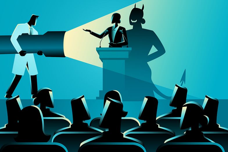 A male scientist shining a torch at a woman giving a lecture, revealing a monstrous shadow. To illustrate being unfairly smeared. A male scientist shining a torch at a woman giving a lecture, revealing a monstrous shadow. To illustrate being unfairly smeared.