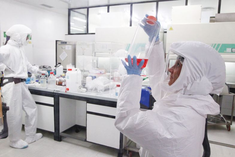 A bacteriologist wears protective suit performs the analysis of a Coronavirus test in the High Security Laboratory A bacteriologist wears protective suit performs the analysis of a Coronavirus test in the High Security Laboratory to show the measures needed for high security