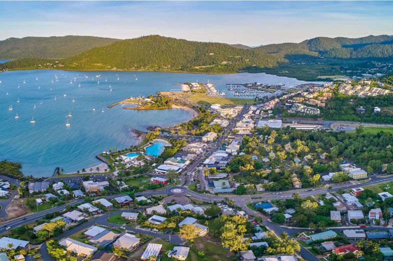 Panorama aerial view of the main street of Airlie beach as mentioned in the copy