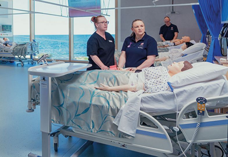 Nursing students practising on a dummy patient