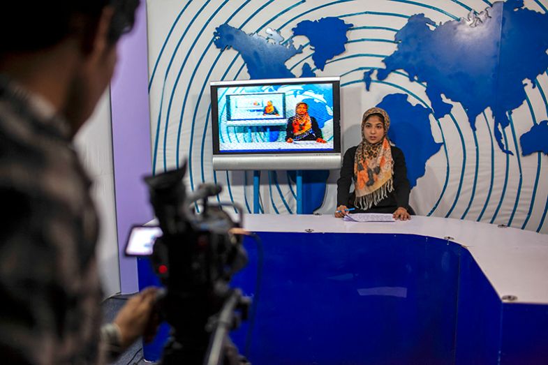 A female news presenter sits at a desk during a television broadcast in a studio in Herat, Afghanistan on 17 July 2012. A female news presenter sits at a desk during a television broadcast in a studio in Herat, Afghanistan on 17 July 2012.