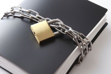 Confidential documents locked with padlock and chain Confidential documents locked with padlock and chain