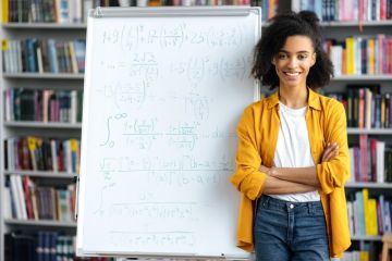 A black academic in front of a white board A black academic in front of a white board