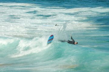A surfer at the southern end of Bondi Beach gets wiped out while surfing a wave A surfer at the southern end of Bondi Beach gets wiped out while surfing a wave