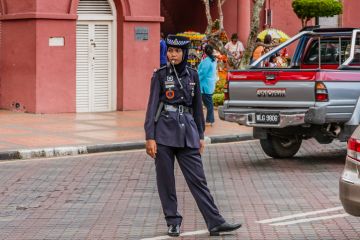 A traffic policewoman wearing hijab at duties, Malacca, Malaysia A traffic policewoman wearing hijab at duties, Malacca, Malaysia