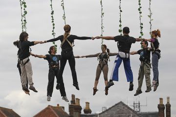 Aerial dancers holding hands, during a dress rehearsal ahead of their performance at the opening night of Salisbury International Arts Festival, England. To illustrate that institutions are increasingly grouping together locally in a bid to be heard. Aerial dancers holding hands, during a dress rehearsal ahead of their performance at the opening night of Salisbury International Arts Festival, England. To illustrate that institutions are increasingly grouping together locally in a bid to be heard.