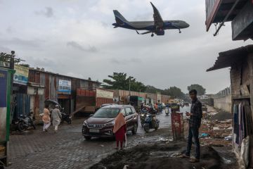 An aeroplane flies over slums in Mumbai An aeroplane flies over slums in Mumbai