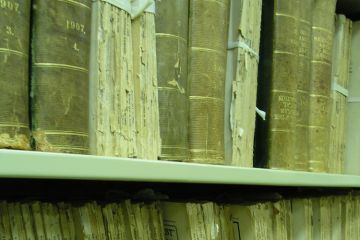 Aged medical journals on shelf