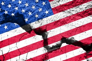 An American flag with a big crack through it