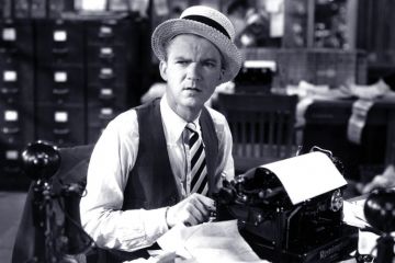 An editor sitting at a typewriter