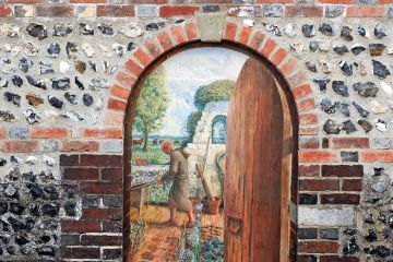 An open door with a painting behind it