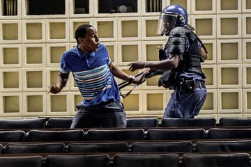 Anti-riot policeman reacts towards student protestor, University of the Witwatersrand Anti-riot policeman reacts towards student protestor, University of the Witwatersrand