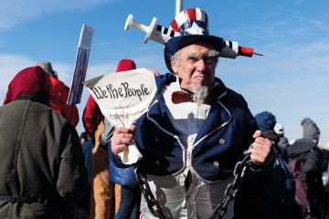 A demonstrator dressed as Uncle Sam stands for a photograph during an anti-vaccine mandate rally at the Washington Monument in Washington, D.C., U.S., on Sunday, Jan. 23, 2022. A demonstrator dressed as Uncle Sam stands for a photograph during an anti-vaccine mandate rally at the Washington Monument in Washington, D.C., U.S., on Sunday, Jan. 23, 2022.